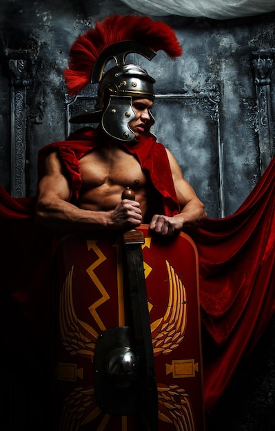 Roman warrior with muscular body holding sword and shield