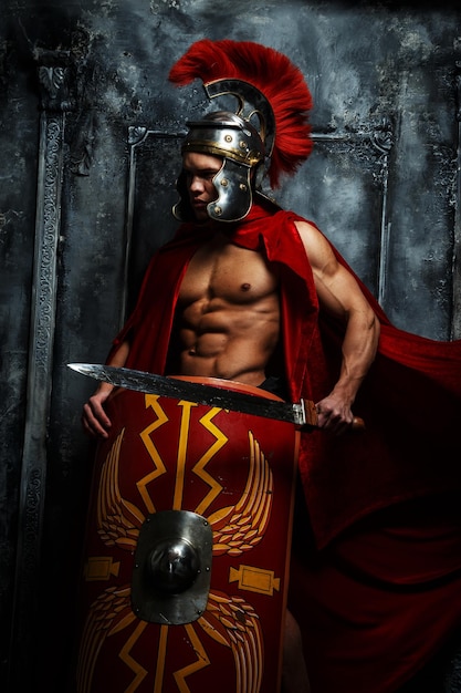 Roman warrior with muscular body holding sword and shield