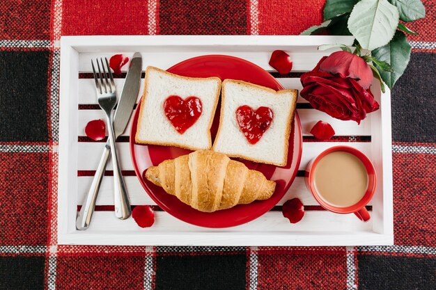 Romantic breakfast on white tray on table 