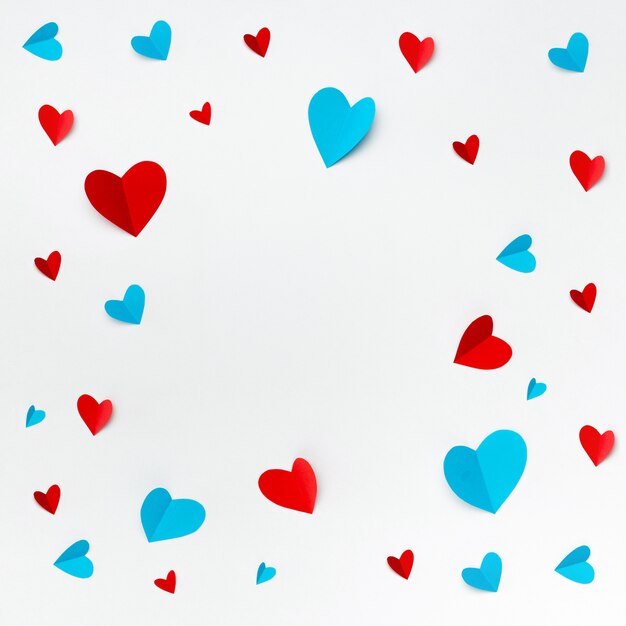 Romantic composition made with red hearts on white background with copyspace for text