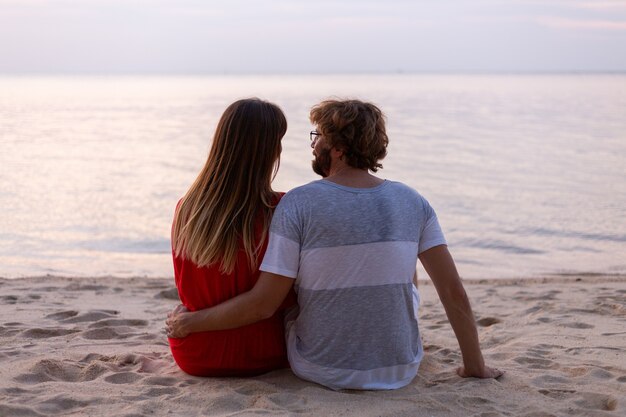 Романтическая пара на пляже на закате