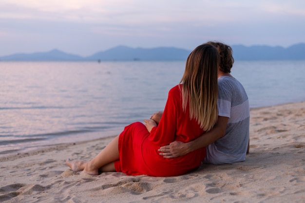 Romantic couple on beach at sunset
