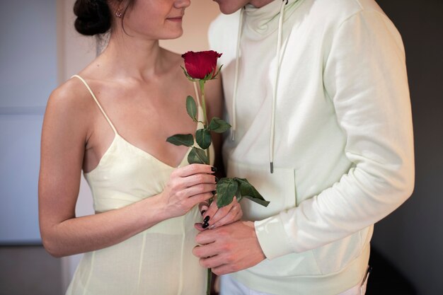 Romantic couple celebrating valentines day with red rose