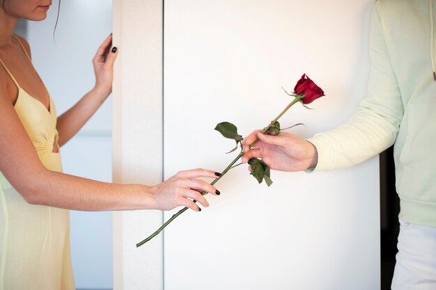 Romantic couple celebrating valentines day with red rose