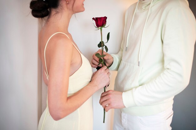 Romantic couple celebrating valentines day with red rose