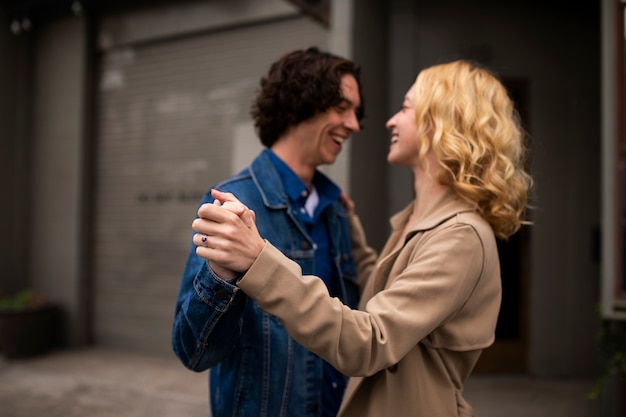 Free photo romantic couple in the city with engagement ring after proposal