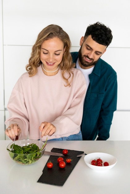 Free photo romantic couple cooking together at home