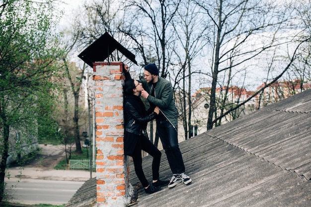 Romantic couple flirting on the roof