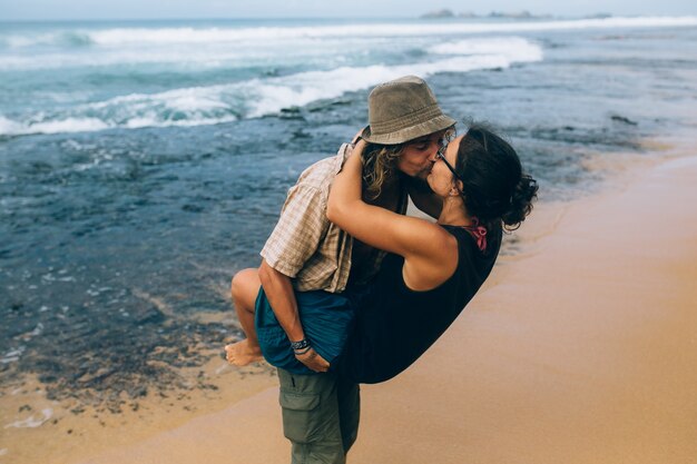 Romantic couple giving a passionate kiss on the seashore