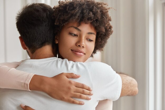 Romantic couple have warm hug indoor