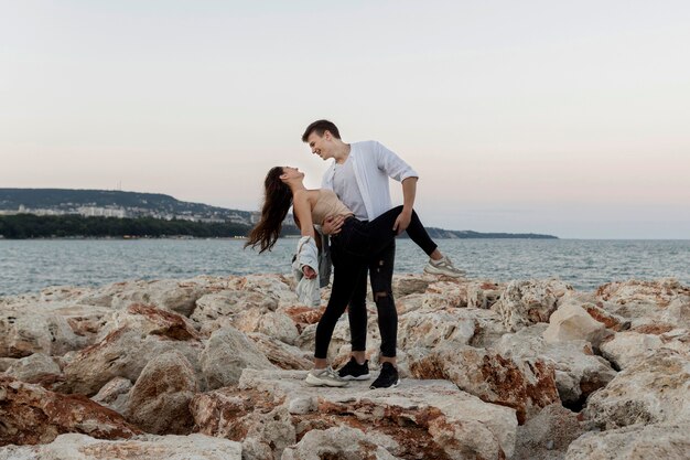 Romantic couple holding each other by the ocean