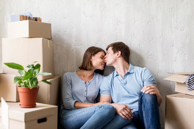 Romantic couple at home taking a break from packing to move out