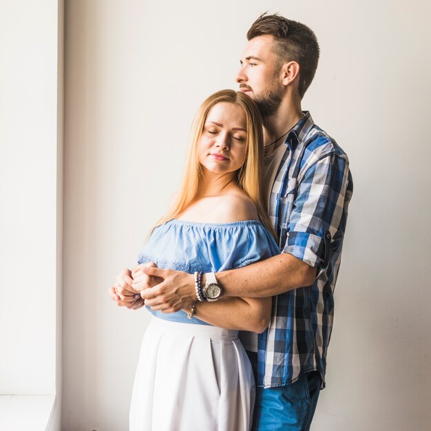 Romantic couple hugging at home