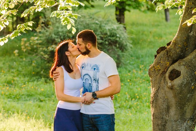 ロマンチックなカップルは、公園でお互いにキス