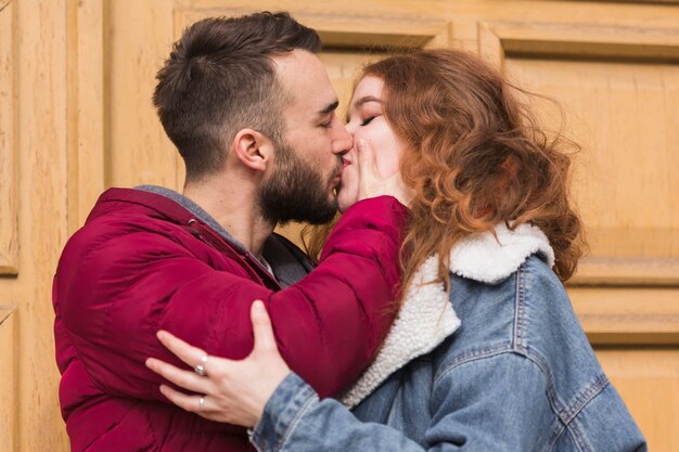 Romantic couple kissing outdoors