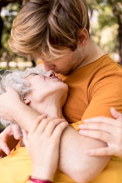 Romantic couple kissing while out in the park