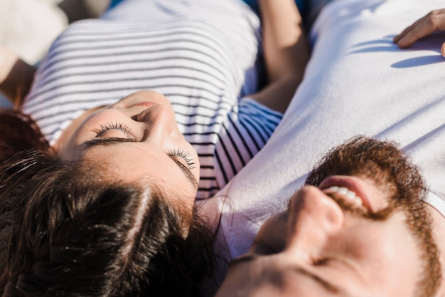 Romantic couple lying on rocks at the sea