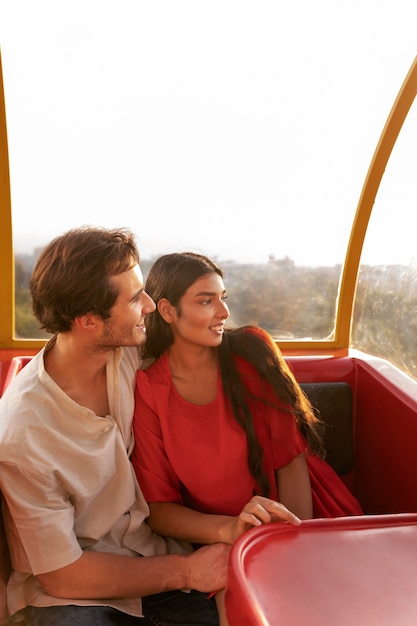 Free photo romantic couple out together at the ferris wheel in the park