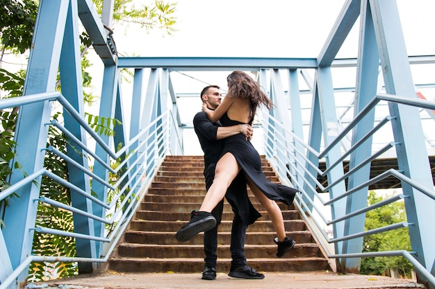 Romantic couple performing on staircase