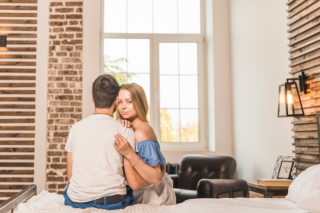 Romantic couple sitting on bed