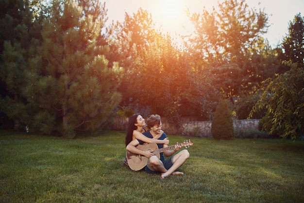 Romantic couple sitting on the grass in the garden