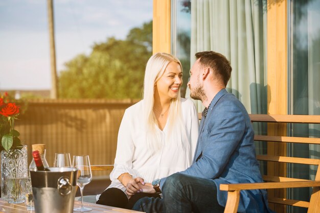 Romantic couple sitting in restaurant loving each other