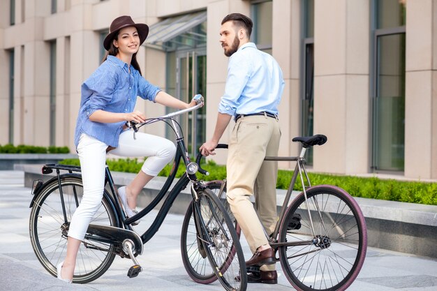 Romantic date of young couple on bicycles