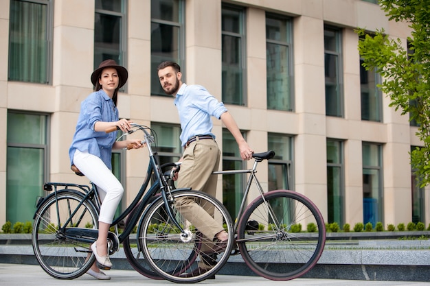Free photo romantic date of young couple on bicycles
