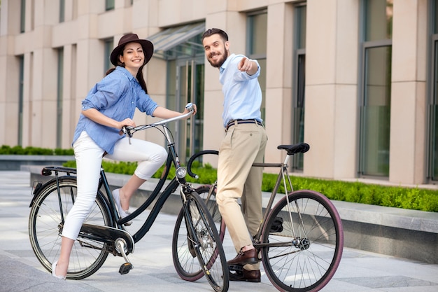 Romantic date of young couple on bicycles
