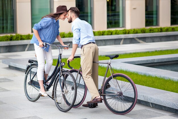 Romantic date of young couple on bicycles