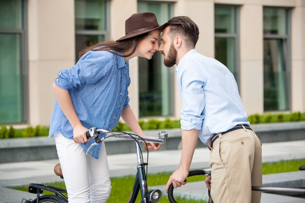 Romantic date of young couple on bicycles