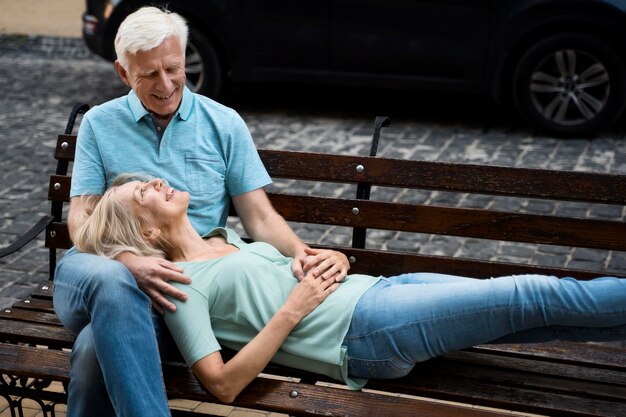 Romantic elder couple enjoying their time on bench outdoors