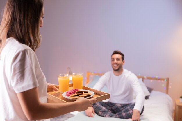 Romantic girl brings breakfast to her husband