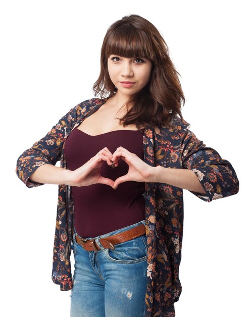 Romantic girl making heart with her hands