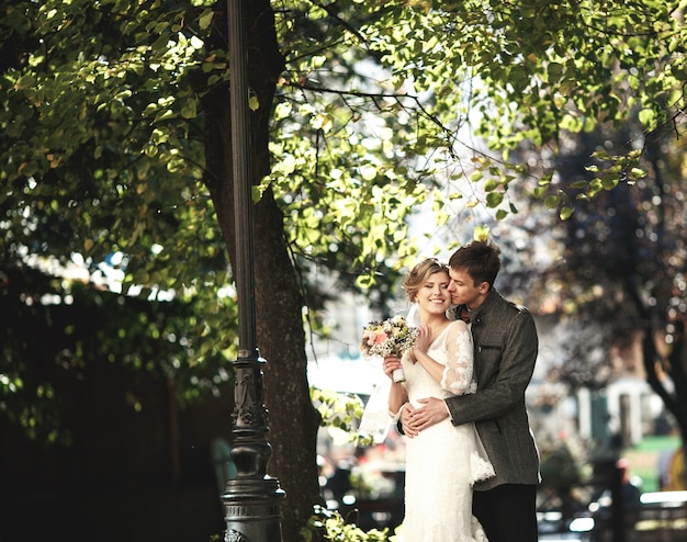 Romantic groom kissing his wife's cheek