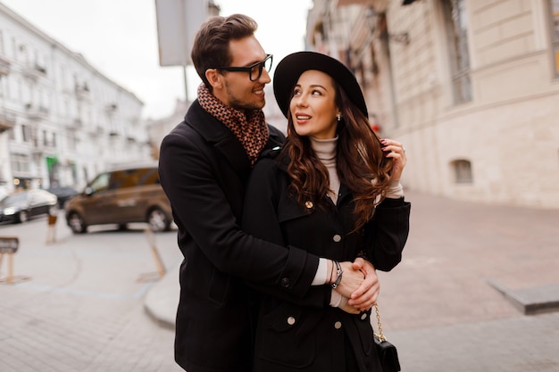 Romantic moments of  beautiful elegant couple in love walking in the city,  hugging and enjoying time together. Warm colors. Valentine