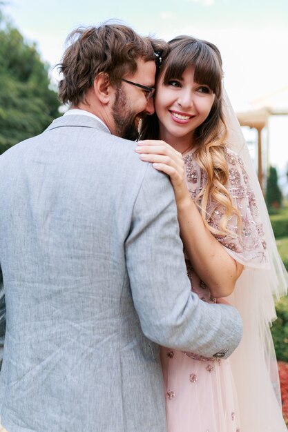 Romantic moments of  wedding couple. Bride  and groom embaracing and enjoing time togethe.