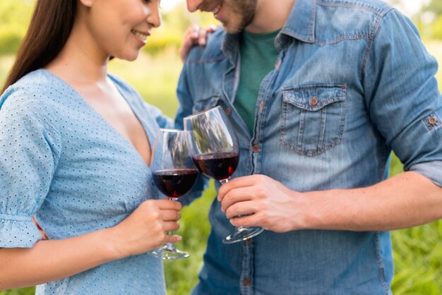 Romantic multiethnic couple clinking wine glasses