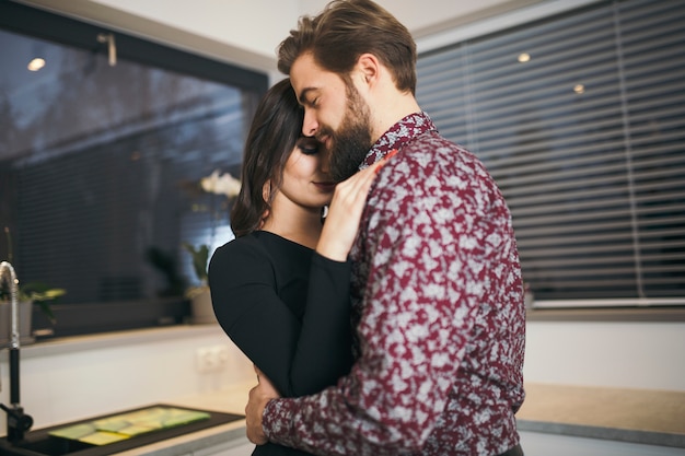 Romantic people embracing gently at home