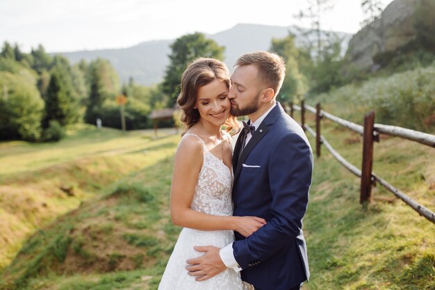 Romantic wedding couple in love walks in the mountains and forest