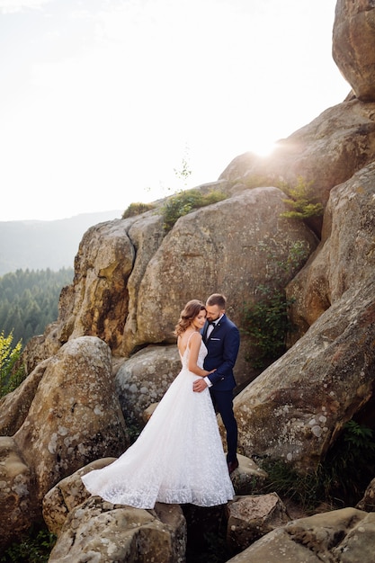 Romantic wedding couple in love walks in the mountains and forest