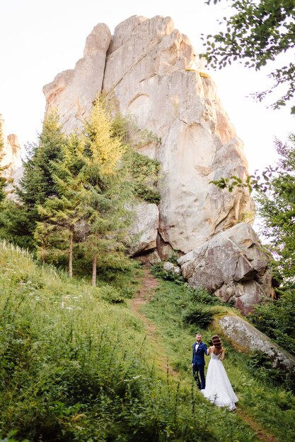 Romantic wedding couple in love walks in the mountains and forest