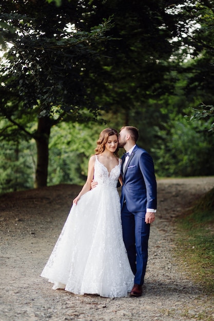 Romantic wedding couple in love walks in the mountains and forest