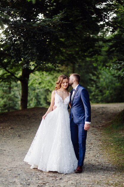 Romantic wedding couple in love walks in the mountains and forest