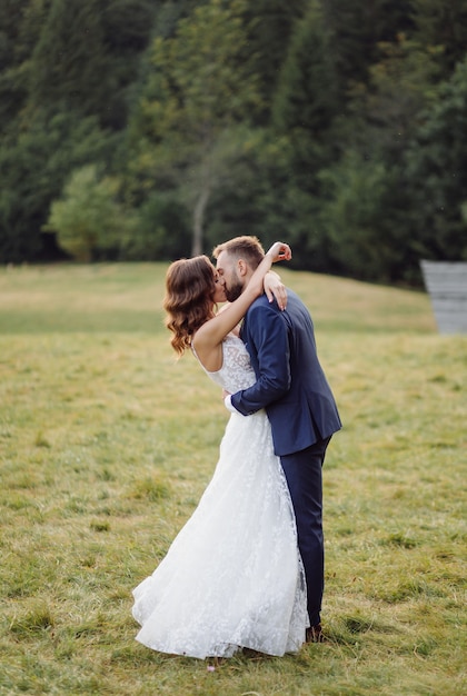 Romantic wedding couple in love walks in the mountains and forest