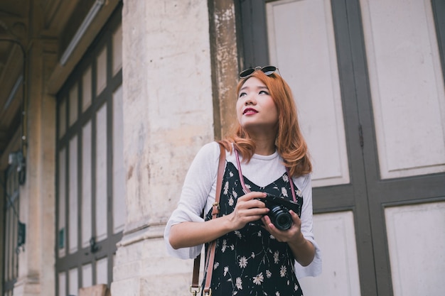 Romantic woman with camera on street