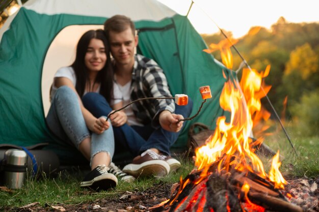 Romantic young couple enjoying bonfire