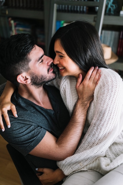 Romantic young couple sitting together loving each other