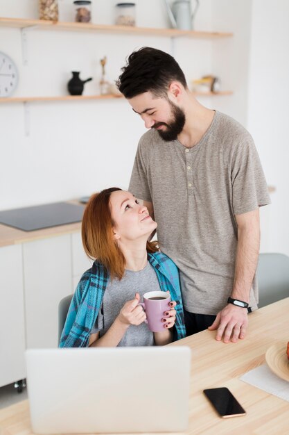 Romantic young couple spending time in the kitchen