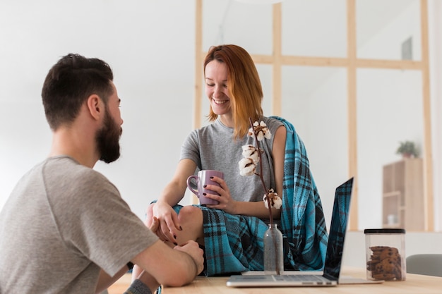 Romantic young couple talking in a kitchen